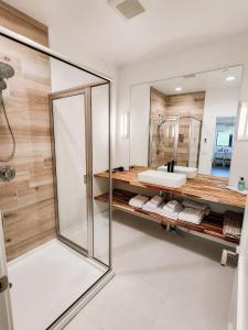 a bathroom with a glass shower and a sink at Wallace BNB in Pinedale