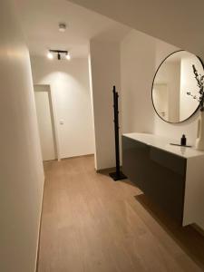 a bathroom with a sink and a mirror at OASIS: Close to Munich - 4 Bedrooms - Kitchen in Dachau