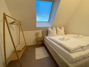 a small room with a bed and a window at OASIS: Close to Munich - 4 Bedrooms - Kitchen in Dachau