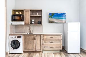 a kitchen with a washing machine and a refrigerator at Sea Esta Studio I - Ideal for Couples! in Turtle Cove