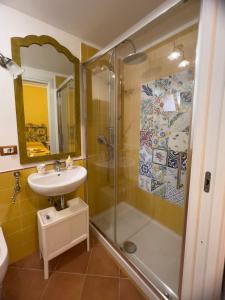 a bathroom with a shower and a sink at Giallo Napoli in Naples