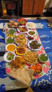 a table topped with lots of different types of food at الضيافة in Shakshuk