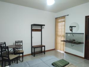 a living room with a table and a table and chairs at Hostel Dom Bosco in São João del Rei