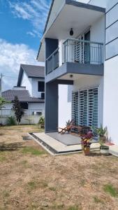 Casa bianca con balcone e cortile di Baituljannah Homestay Batu Pahat a Batu Pahat