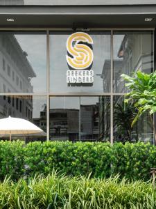 曼谷的住宿－Seekers Finders Rama IV Hotel SureStay Collection by BW，建筑物窗户上的标志