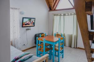 una mesa pequeña y sillas en una habitación con cama en KUPAL en Esquel