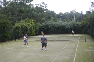 a group of people playing tennis on a tennis court at Holiday with Nature in Cooran
