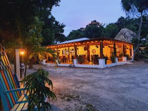 a house is lit up at night with lights at Ernesto Hotel & Restaurante in El Remate