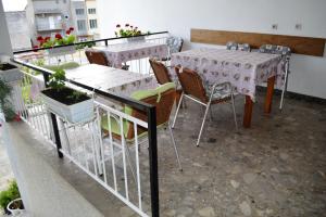 a balcony with two tables and chairs on a balcony at Apartment LEMONA in Makarska