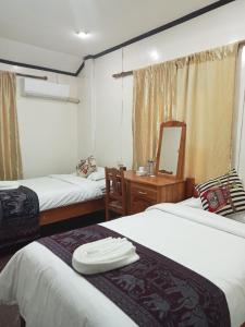 Postel nebo postele na pokoji v ubytování Janh Ya Phone Guesthouse
