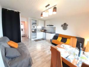 a living room with a couch and a dining table at Appartement Saint-Lary-Soulan, 2 pièces, 4 personnes - FR-1-457-308 in Saint-Lary-Soulan