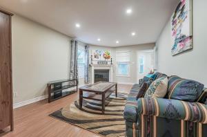 a living room with a couch and a table at Luxury 4 Bedroom/5 Bathroom Huge Ravine Backyard in Richmond Hill