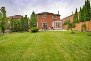 a large yard in front of a brick house at Luxury 4 Bedroom/5 Bathroom Huge Ravine Backyard in Richmond Hill