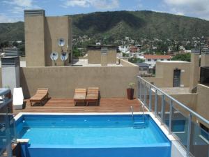 a swimming pool on the roof of a building at Village Tower in Villa Carlos Paz