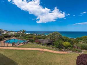 an aerial view of a yard with a swimming pool and the ocean at 23 Sunseeker in Sunshine Beach