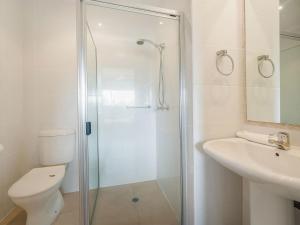 a bathroom with a shower and a toilet and a sink at 23 Sunseeker in Sunshine Beach