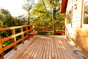 a wooden deck on the side of a house at Chile Wild - Las Vertientes in Malalcahuello