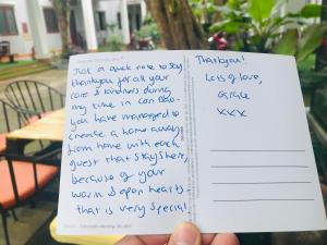 a person holding up a piece of paper with handwriting at Eden House & Coffee Con Dao in Con Dao