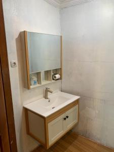 a bathroom with a sink and a mirror at Resort & Resto Talaga Sundayana in Subang