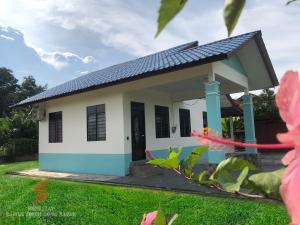 a small house is shown with a green yard at Airport View Homestay Kuala Terengganu in Kuala Terengganu