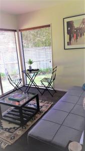 a living room with a table and chairs and windows at Quiet location ,central to city in Hamilton