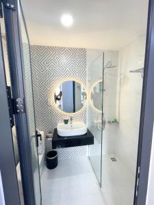 a bathroom with a sink and a mirror at An Nhi Hotel in Da Lat