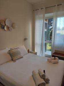 a bedroom with a white bed with towels on it at Domus Cese in Agrigento