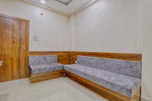 a waiting room with two benches in a room at Hotel Kumar Atithi Nivas in Indore