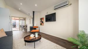 a living room with a couch and a table at Sunshine Retreat Villa 6 in Cowes +2 photos