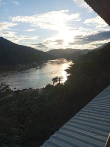 a view of a river with the sun in the distance at Janh Ya Phone Guesthouse in Pakbeng