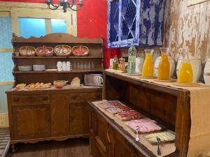 a kitchen with a counter with food and orange juice at Posada d'Àneu in Esterri d'Àneu