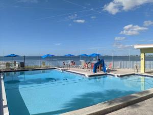 une grande piscine avec toboggan en face de l'océan dans l'établissement Tampa Bay Breeze Direct Bay View From Porch, à Tampa