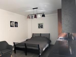 a bedroom with a bed and a chair and lights at Maria's Apartment 2 in Galata