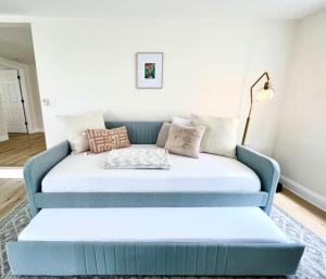 a blue couch with pillows on it in a living room at Fantastic Boho Chic Home Clearwater St Pete Tampa in Largo