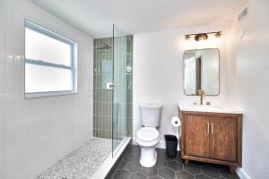 a bathroom with a toilet and a glass shower at Fantastic Boho Chic Home Clearwater St Pete Tampa in Largo +36 photos