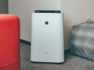 a white refrigerator sitting on the floor next to a pillow at Toyohashi Station Hotel / Vacation STAY 66965 in Toyohashi