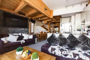 a living room with a couch and a table at Luxury Avoriaz Chalet with hot tub in Avoriaz