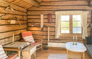 a room in a log cabin with a table and chairs at 3 Bedroom Nice Home In Kvam in Kvam