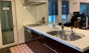 a kitchen with a sink and a counter at Avanti Chalet Hakuba in Hakuba +31 photos