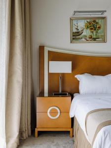 迪拜Belle Vue Building的一间卧室配有一张床和一张带台灯的桌子