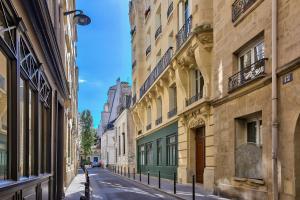 an empty street in a city with buildings at 140 - Urban Duplex near Saint-Germain des Pres in Paris