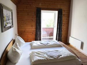 a bedroom with two beds in front of a window at Alpen Chalet Bramberg in Bramberg am Wildkogel