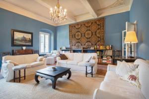 a living room with white furniture and a chandelier at Villa Oleandra with Pool up to 12 People in Volta Mantovana