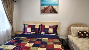 a bedroom with a bed with a quilt on it at Gowrie Agapanthus in Singleton