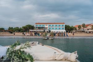 a boat in the water in front of a building at Hôtel George Sand in La Seyne-sur-Mer