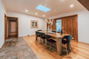 a dining room with a wooden table and chairs at Olinda Nature Retreat 4 Bed 3Bth House Fire, Bath in Olinda