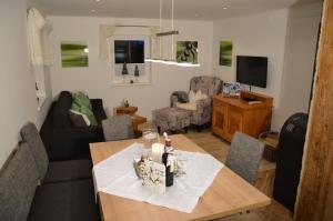 a living room with a table and a couch at Ferienhaus Christine in Taxenbach