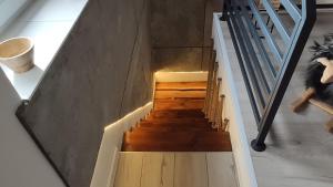 a staircase in a house with wooden flooring and a stair case at Dobry Dom I in Staszów
