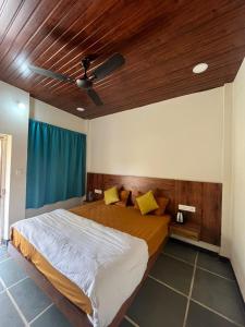a bedroom with a bed with a ceiling fan at The Offbeat Lounge in Udaipur