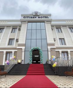 a red carpet leading to the entrance to a hotel at CITIZEN HOTEL in Nukus